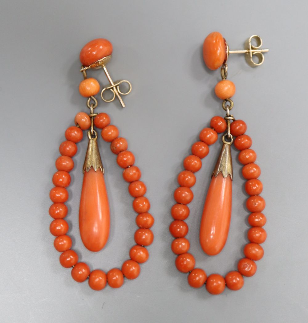 A pair of 9ct mounted coral bead earrings of open teardrop form, overall 51mm, gross 9 grams.